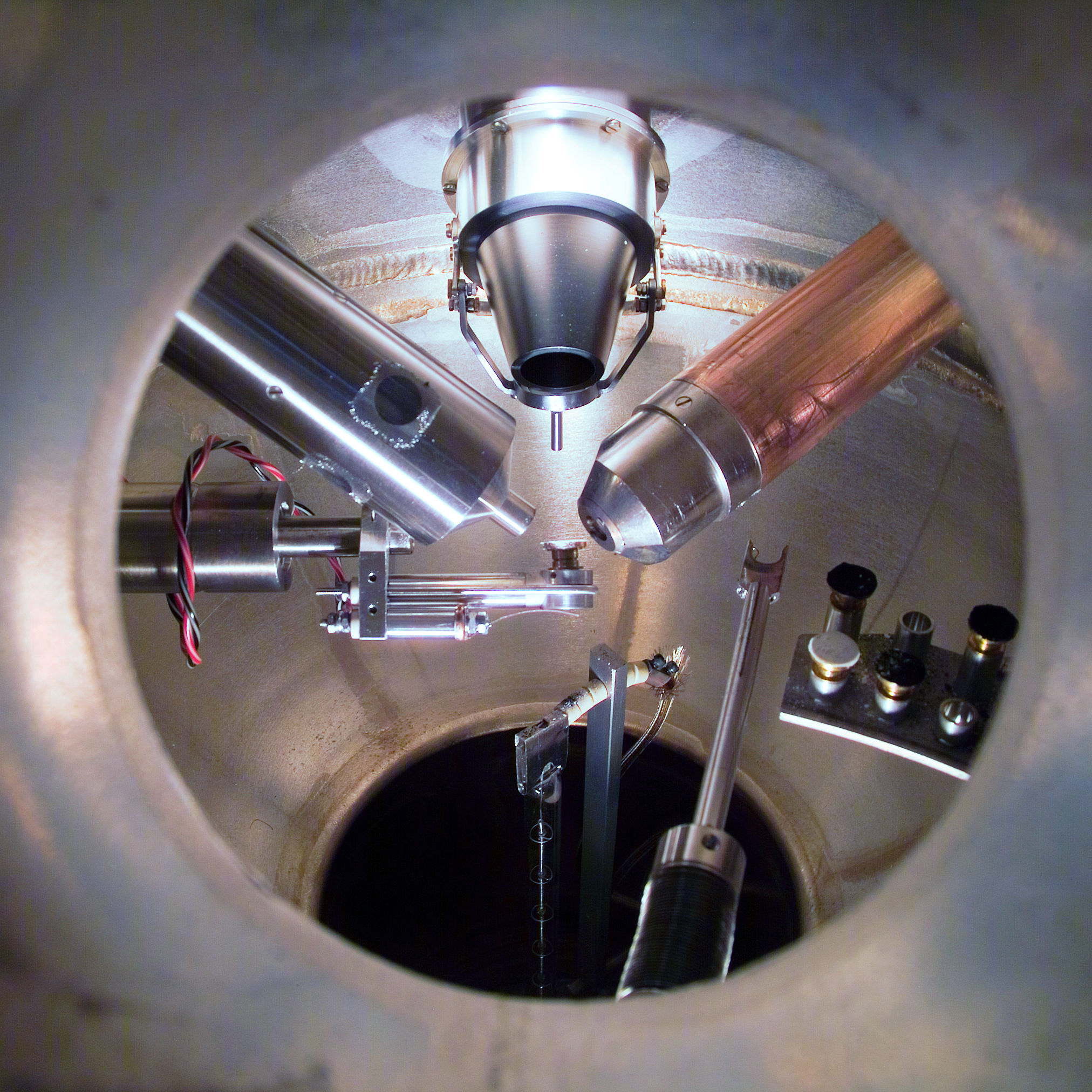 This is the inside of a surface chemical analysis system viewed through a viewport. The sample is at the focal point of many different probes, including sources of ions, electrons, and X rays. Typical techniques include Auger Electron Spectroscopy (AES) and X-ray Photoelectron Spectroscopy (XPS)